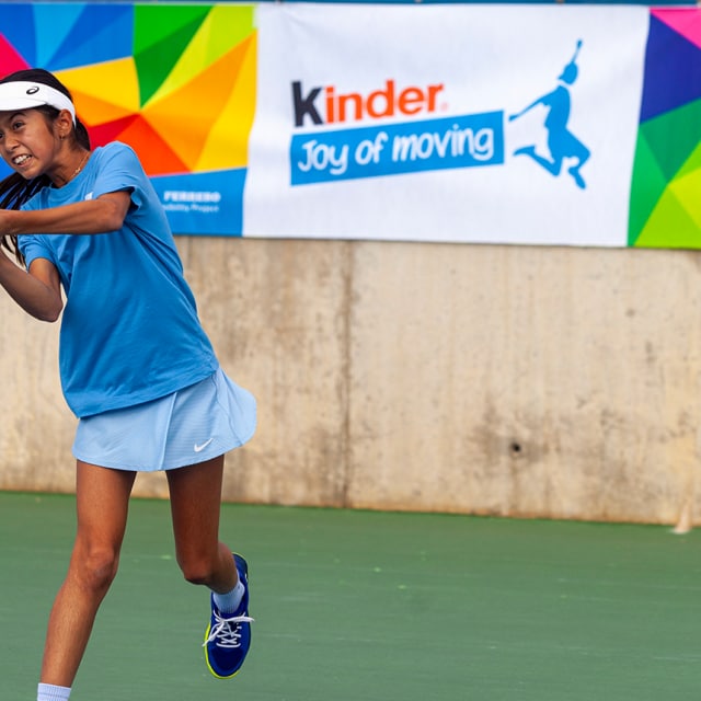kid playing tennis